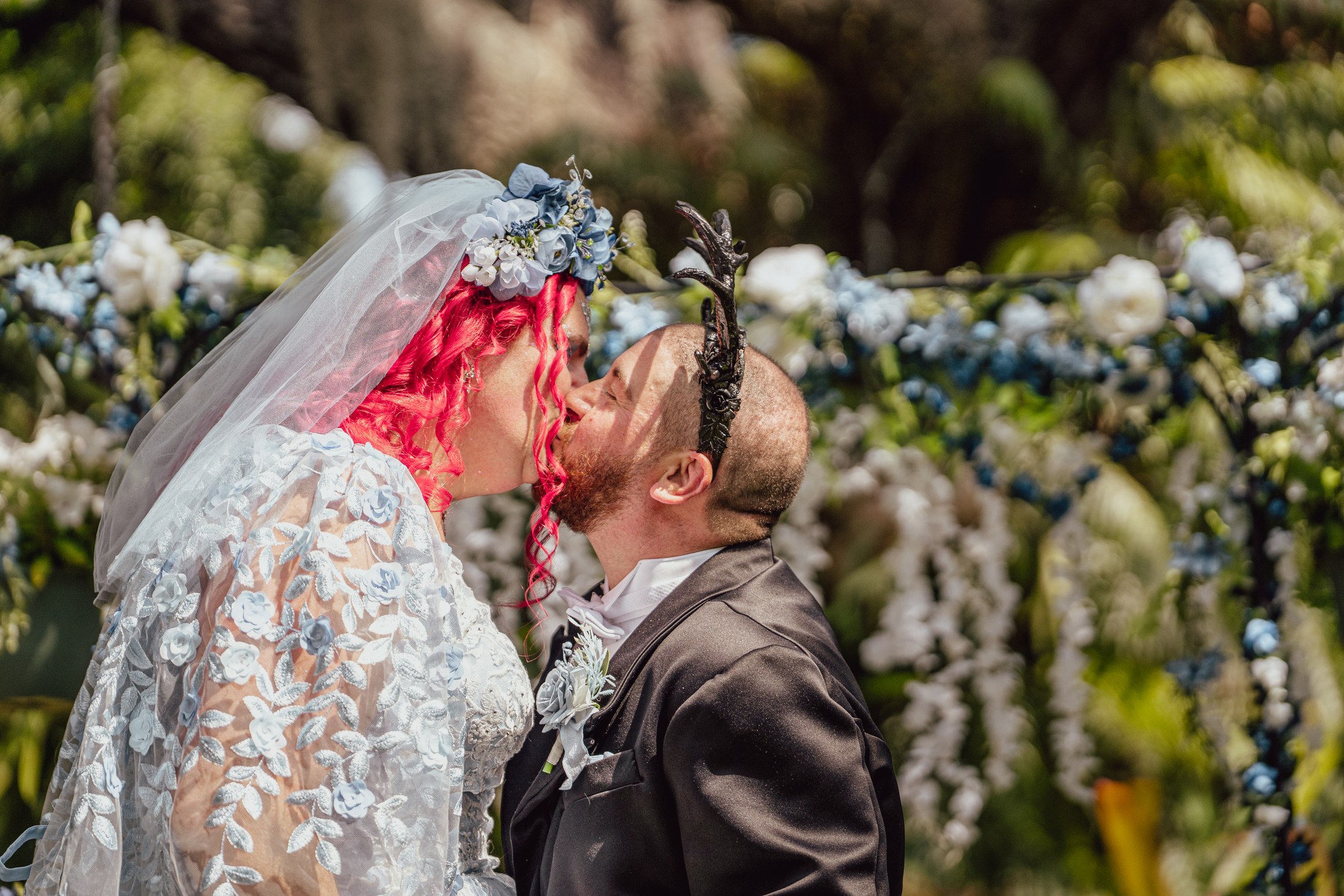 Newlyweds kissing during their outdoor ceremony