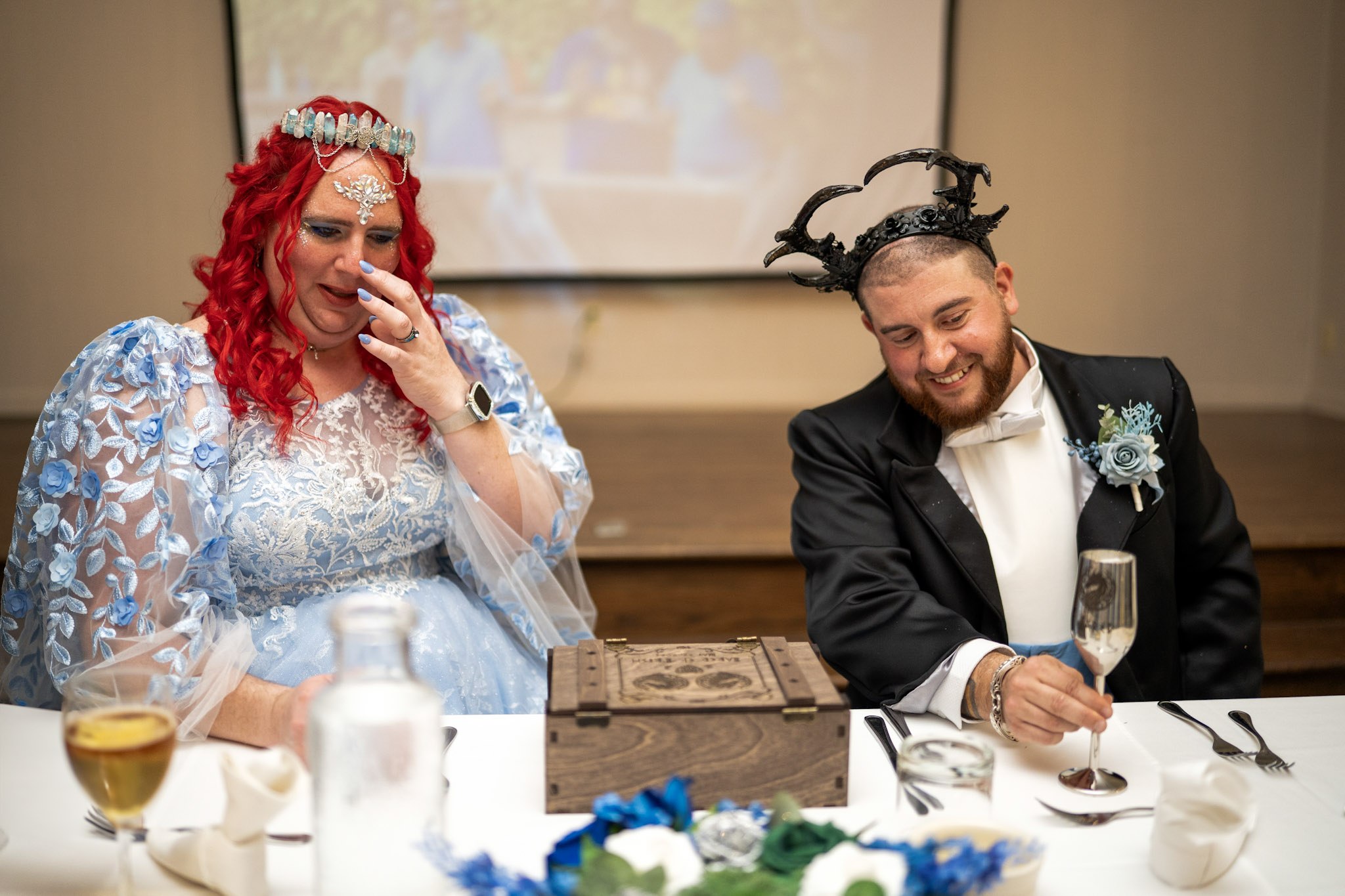 Newlyweds laughing together at their reception