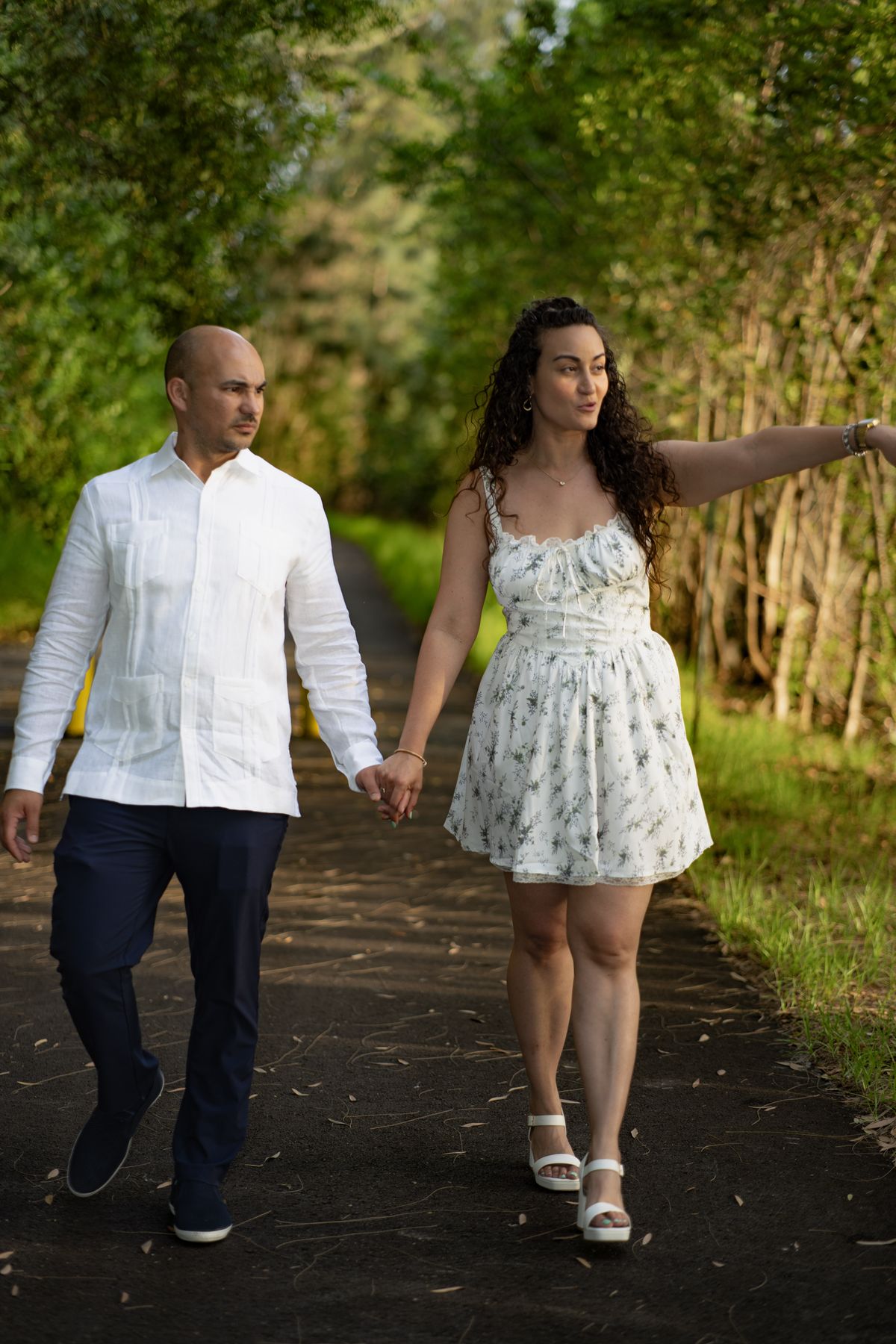 Couple walking along a wooded path