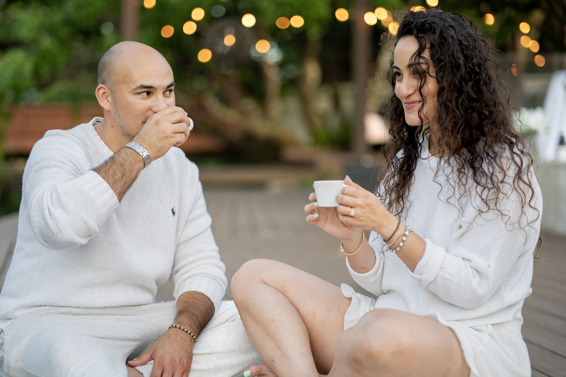 Couple raising glasses together outdoors