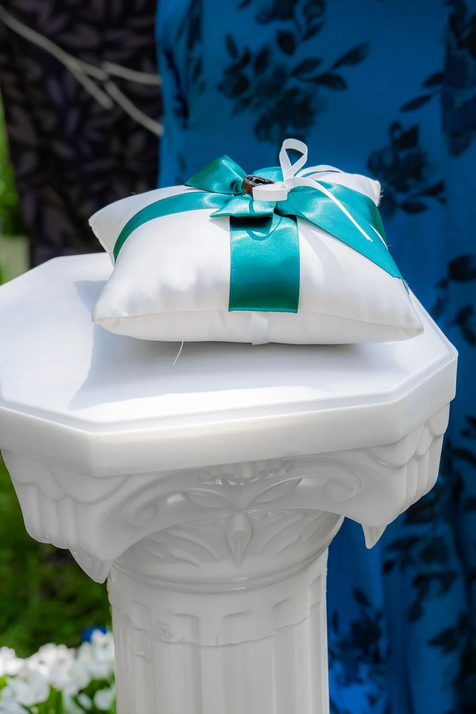 Wedding rings arranged on a decorative ring pillow